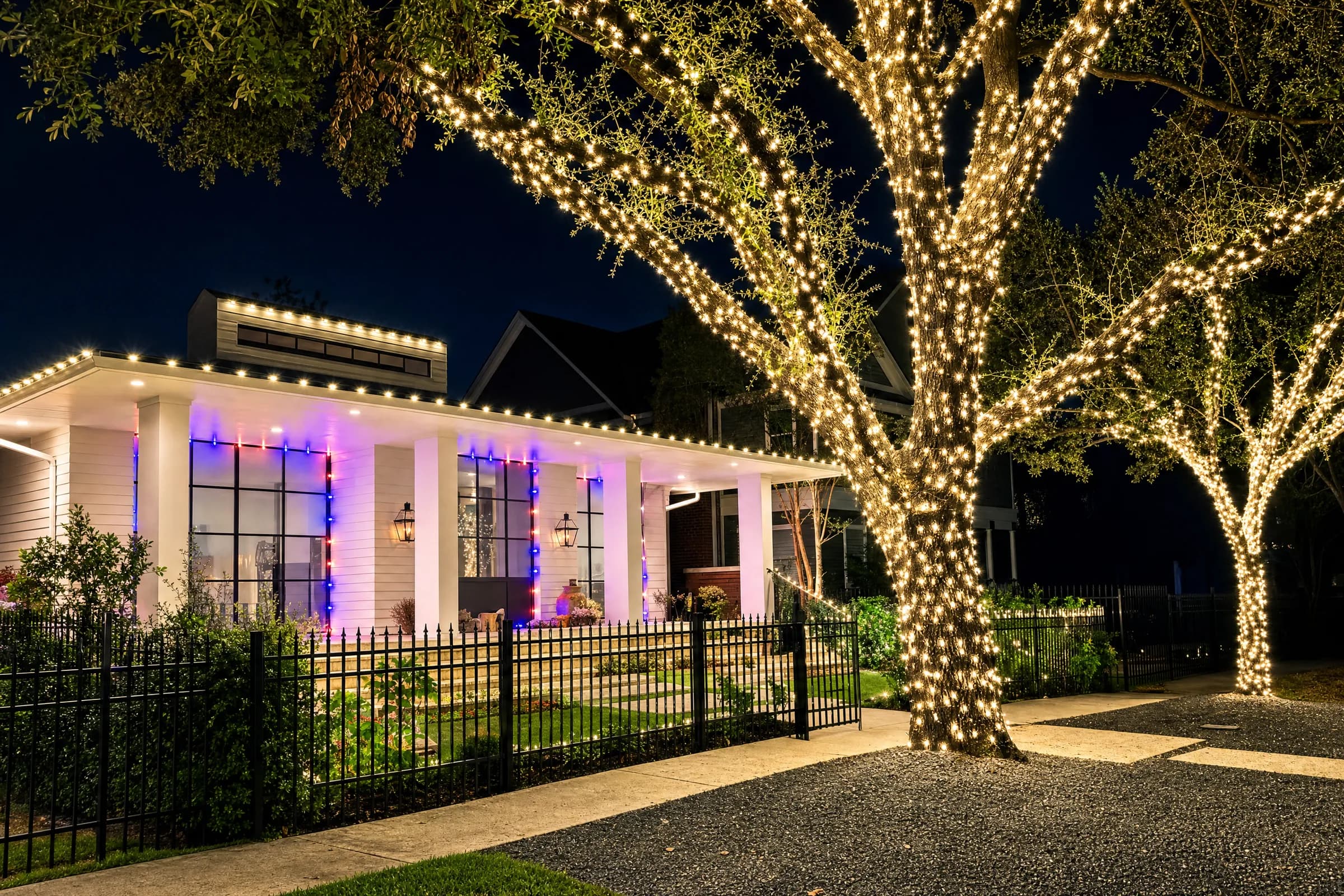 Historic Victorian home in the Houston Heights with warm-white roofline Christmas lights at night