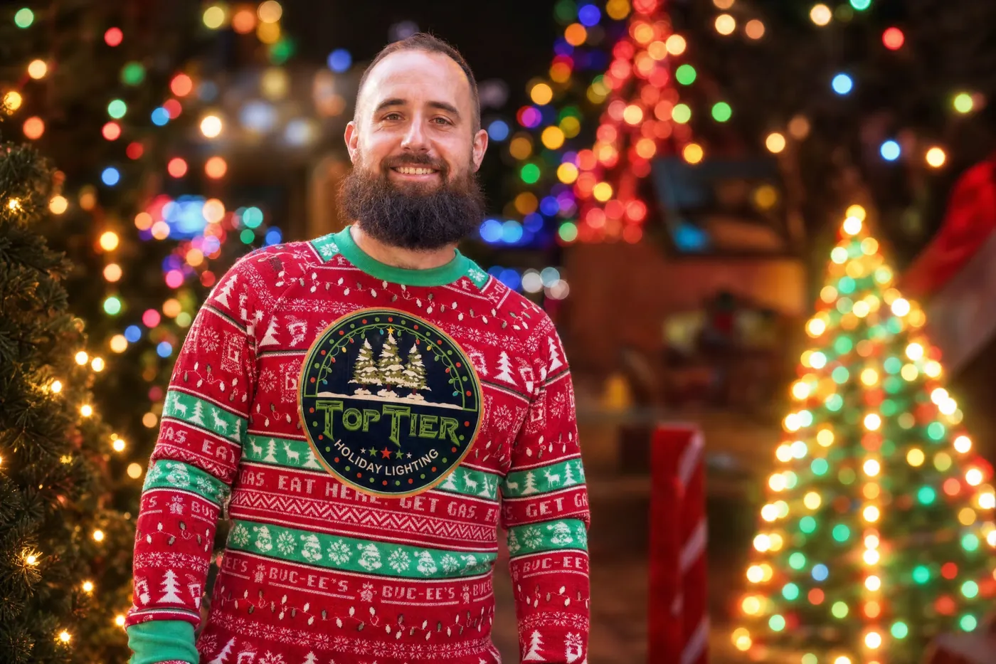 Amar, owner of Top Tier Lights, a Tanglewood-area Christmas light installer, in a Top Tier holiday sweater