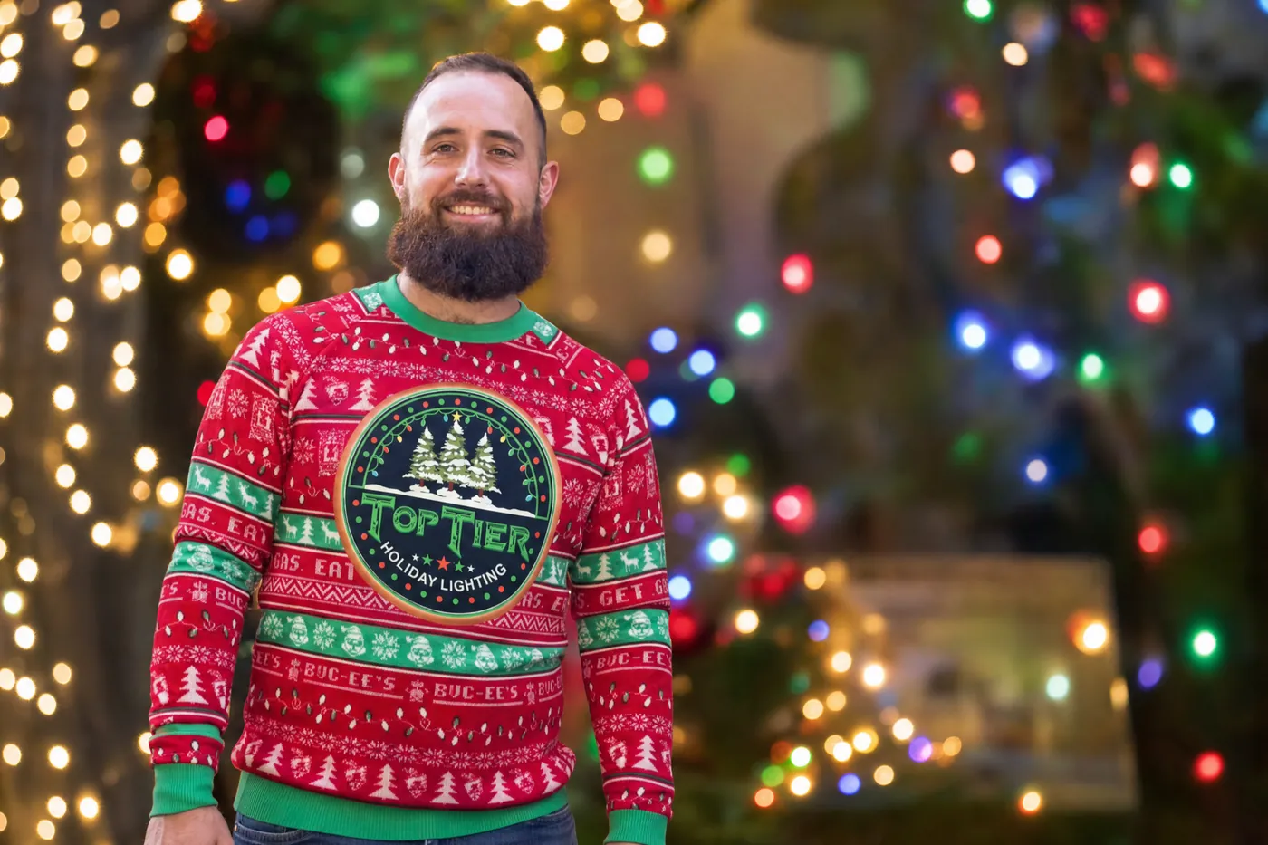 Amar, owner of Top Tier Lights, a Kingwood-area Christmas light installer, in a Top Tier holiday sweater