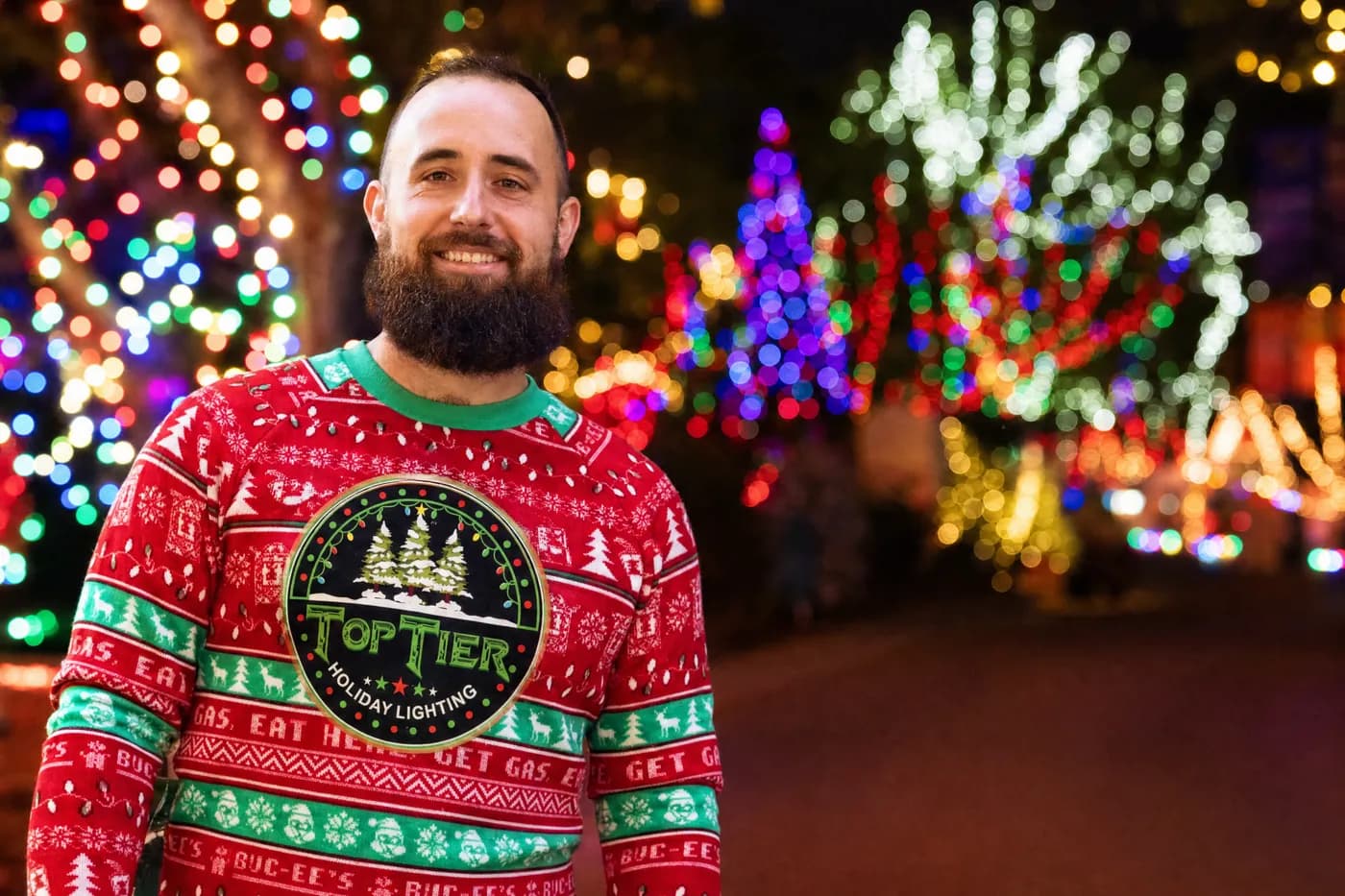 Amar, owner of Top Tier Lights, a Cinco Ranch and Katy Christmas light installer, in a Top Tier holiday sweater