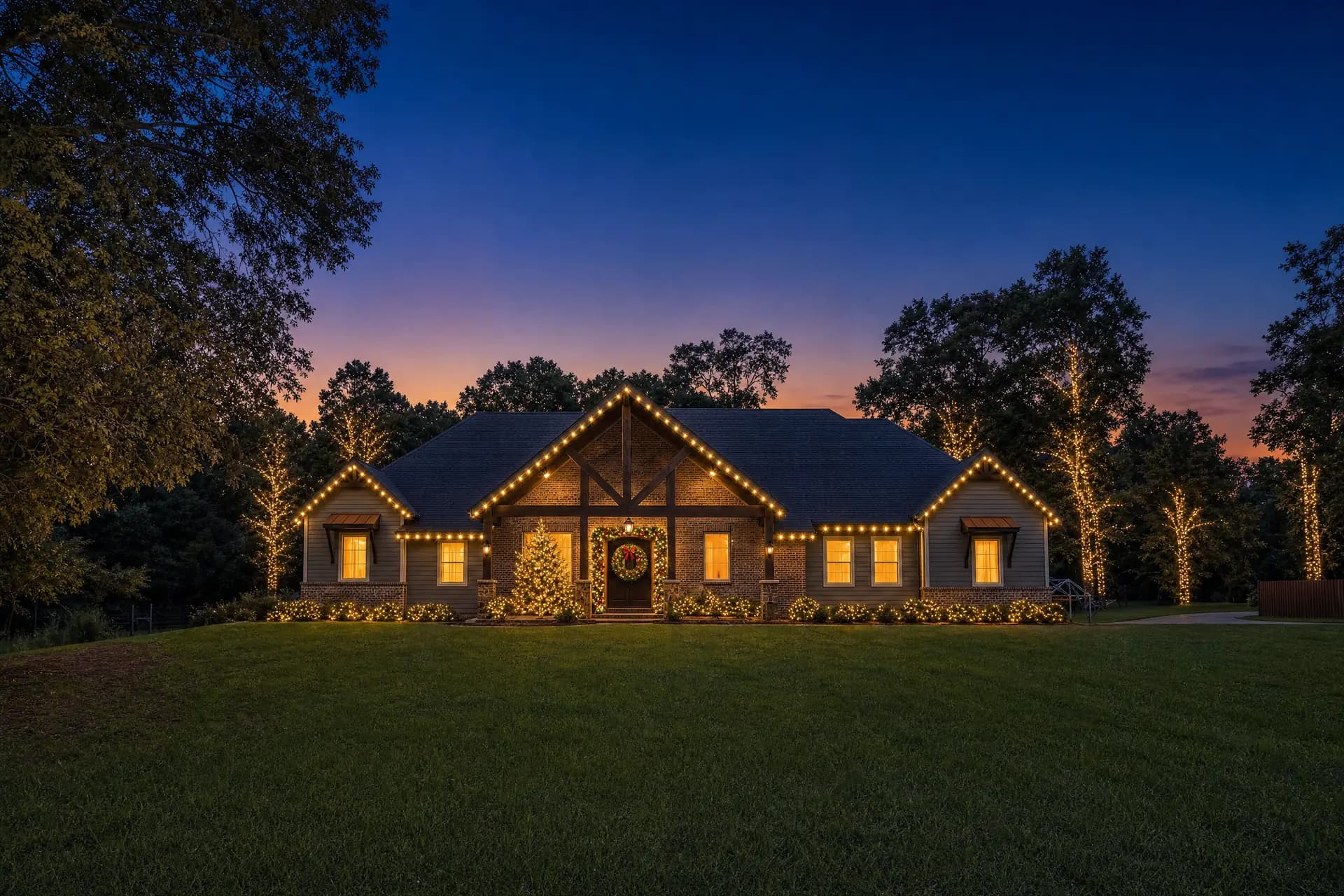 Professional Christmas lights glowing on a home in Magnolia, TX at night