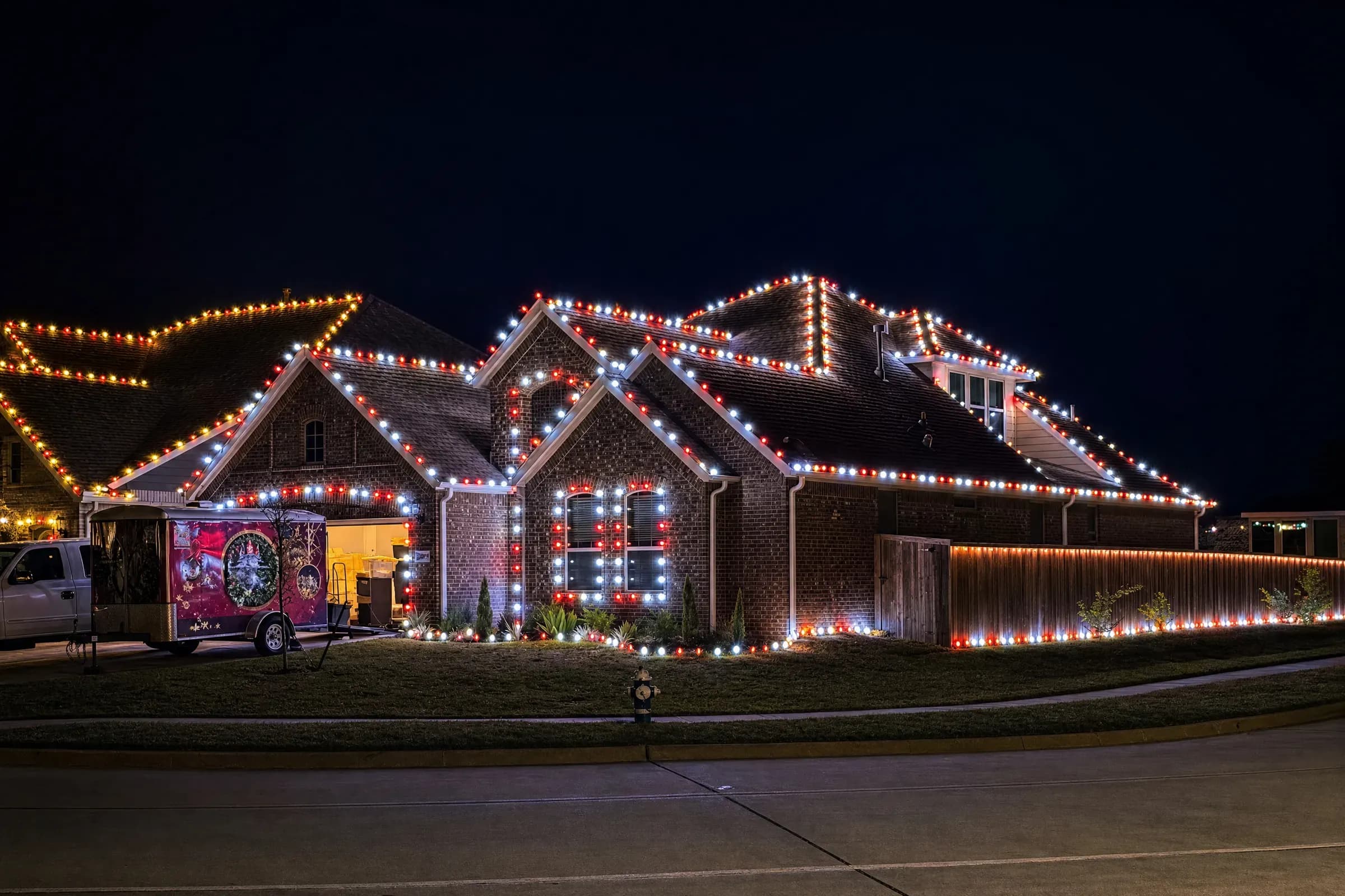 Red and white Christmas light display on a large brick home in New Caney, TX